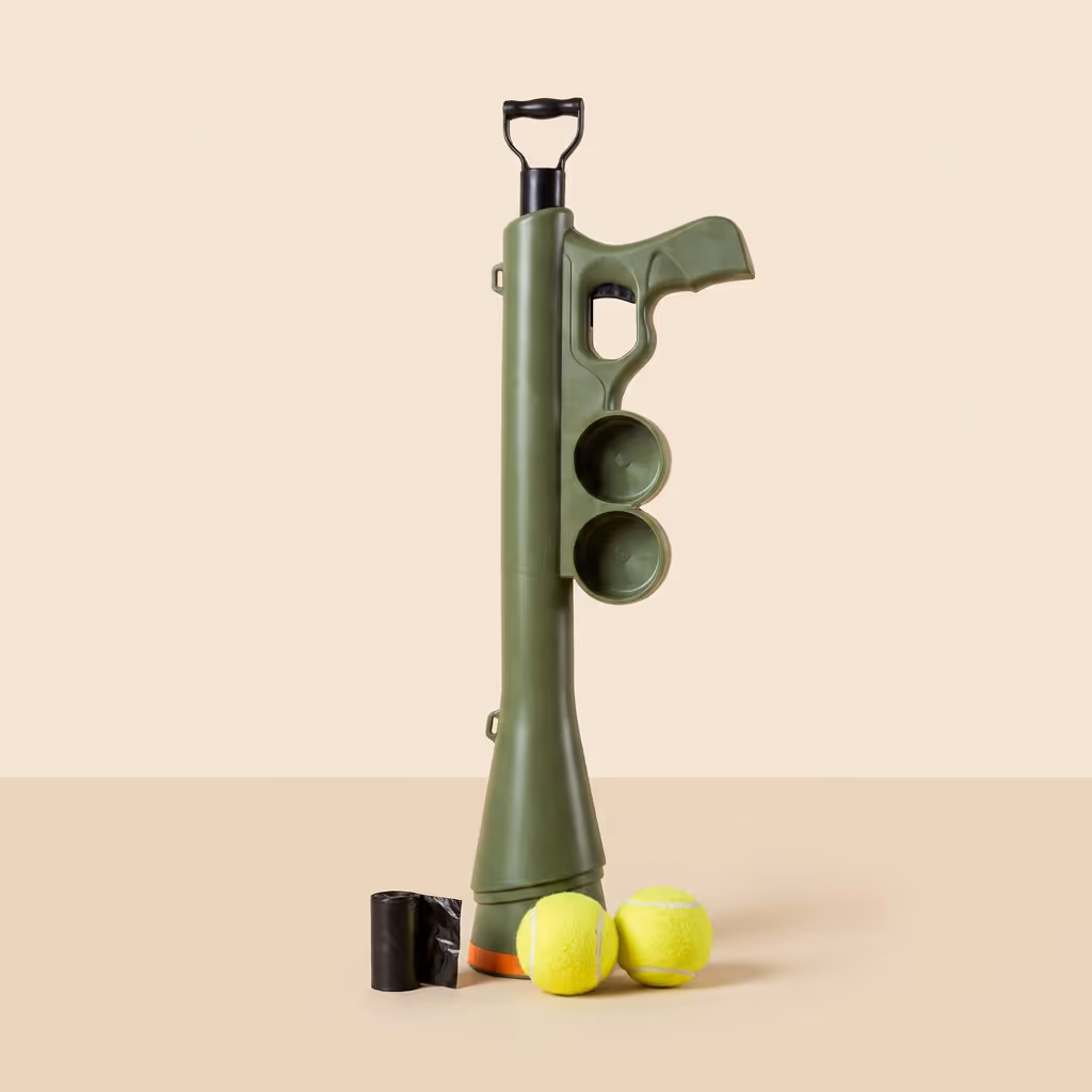 Full product bundle displayed together showing thrower, strap, tennis balls, and poo bags