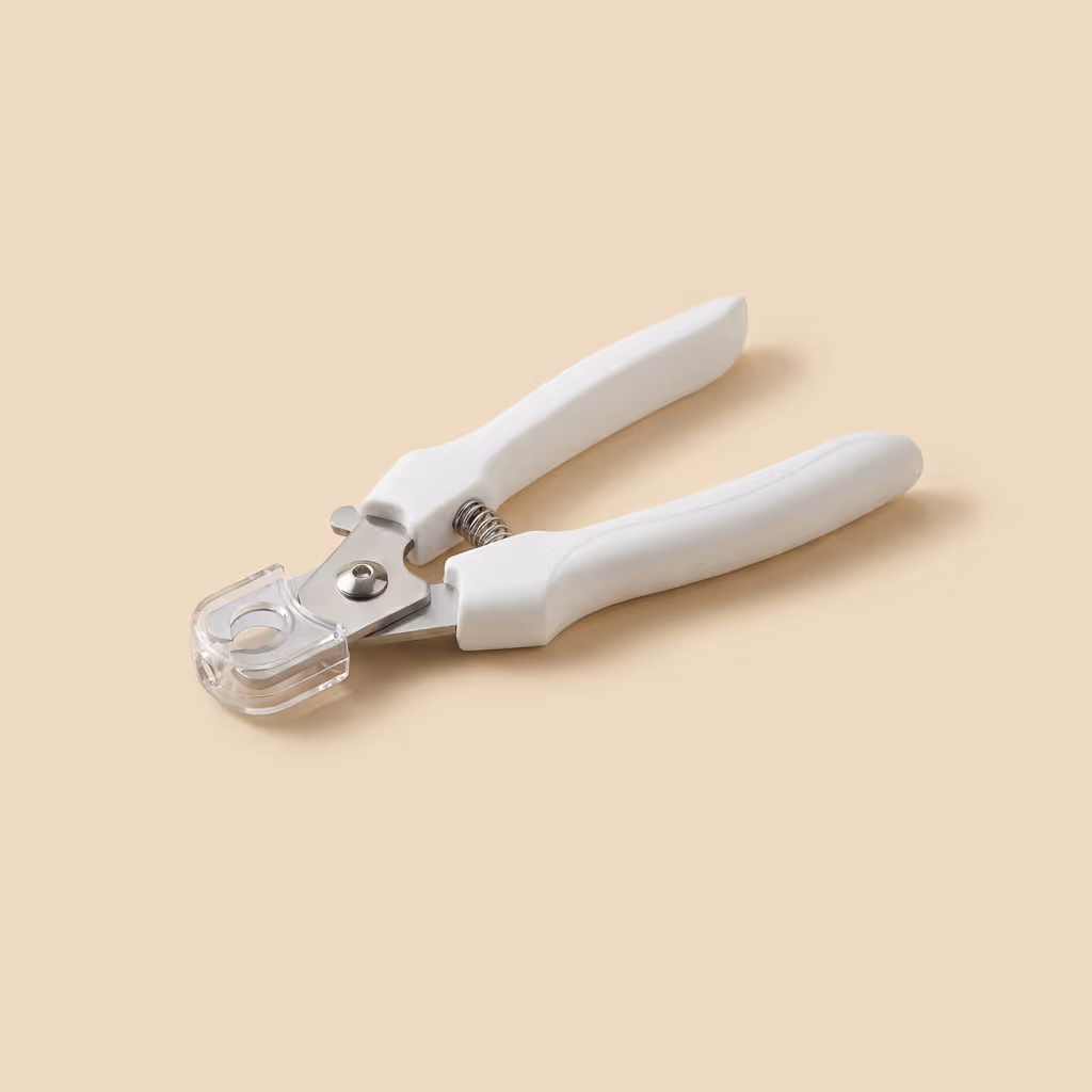 Pet owner trimming dog nails safely using the illuminated rechargeable clipper